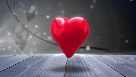 corazón rojo girando en un fondo brillante
