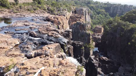 Waterfall-plunges-down-into-rocky-gorge-in-African-bush