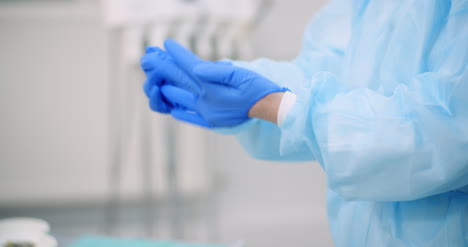 doctor puts blue protective gloves on hands at healt care clinic 3