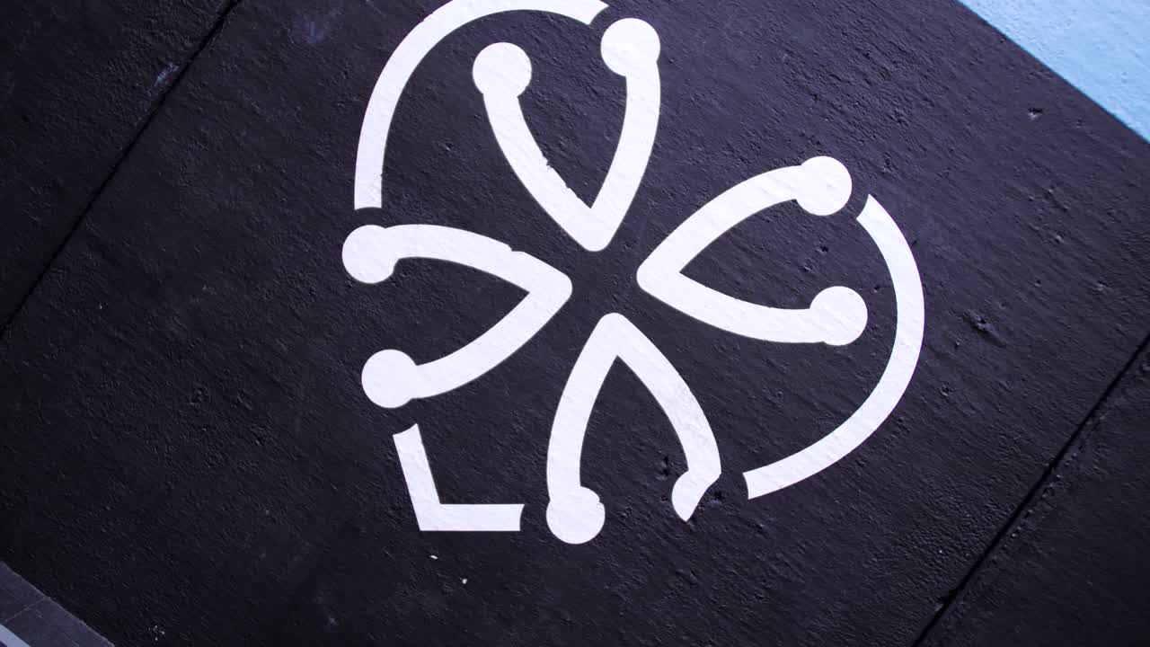 A black and white logo of the gym is displayed on the wall, representing the establishment's identity and brand