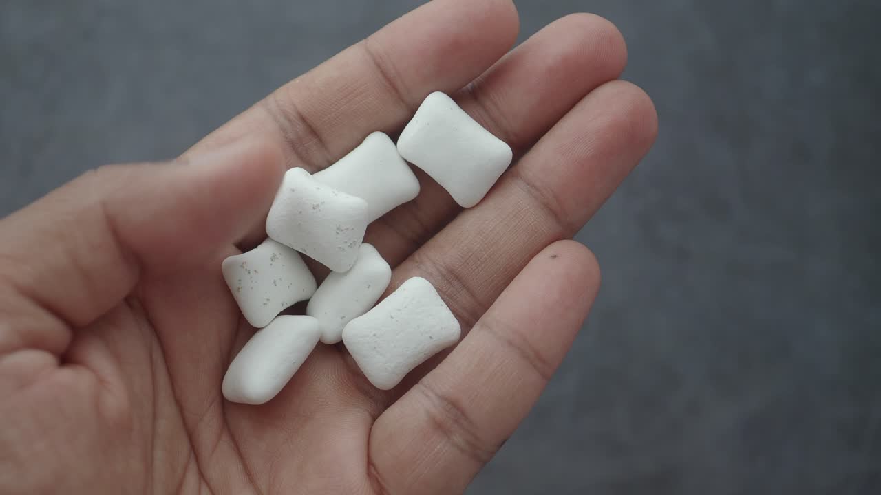 Hand holding chewing gum