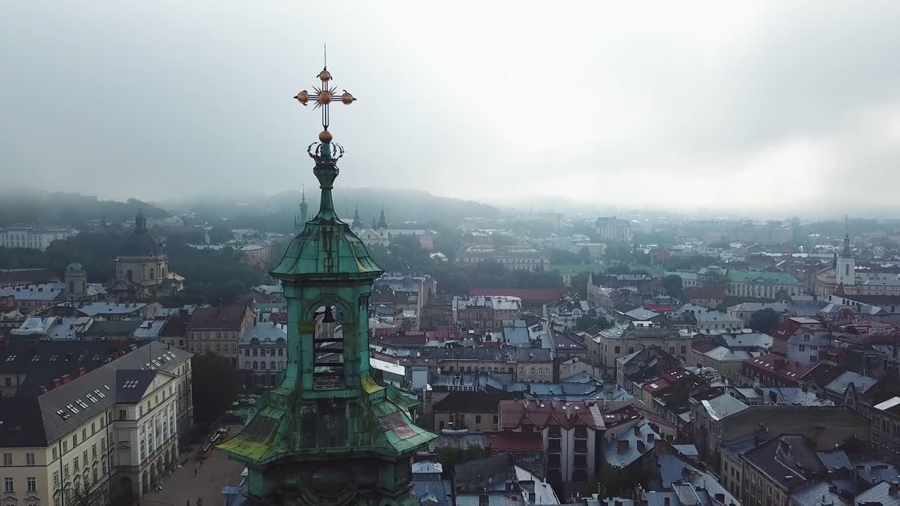 Panorama of the city Lviv from the tall old cathedral. The roofs of old buildings. Aerial view. Camera moves bottom up