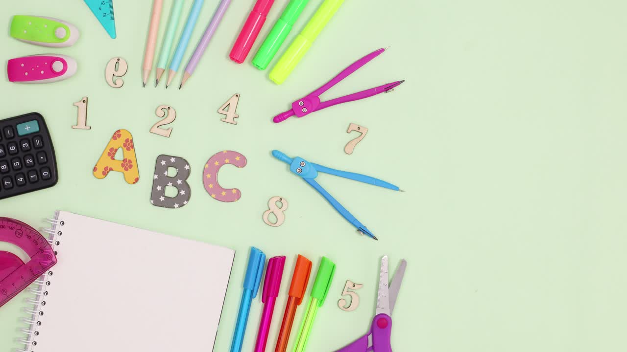 Back to school stationery appear on left side of light green theme. Stop motion flat lay