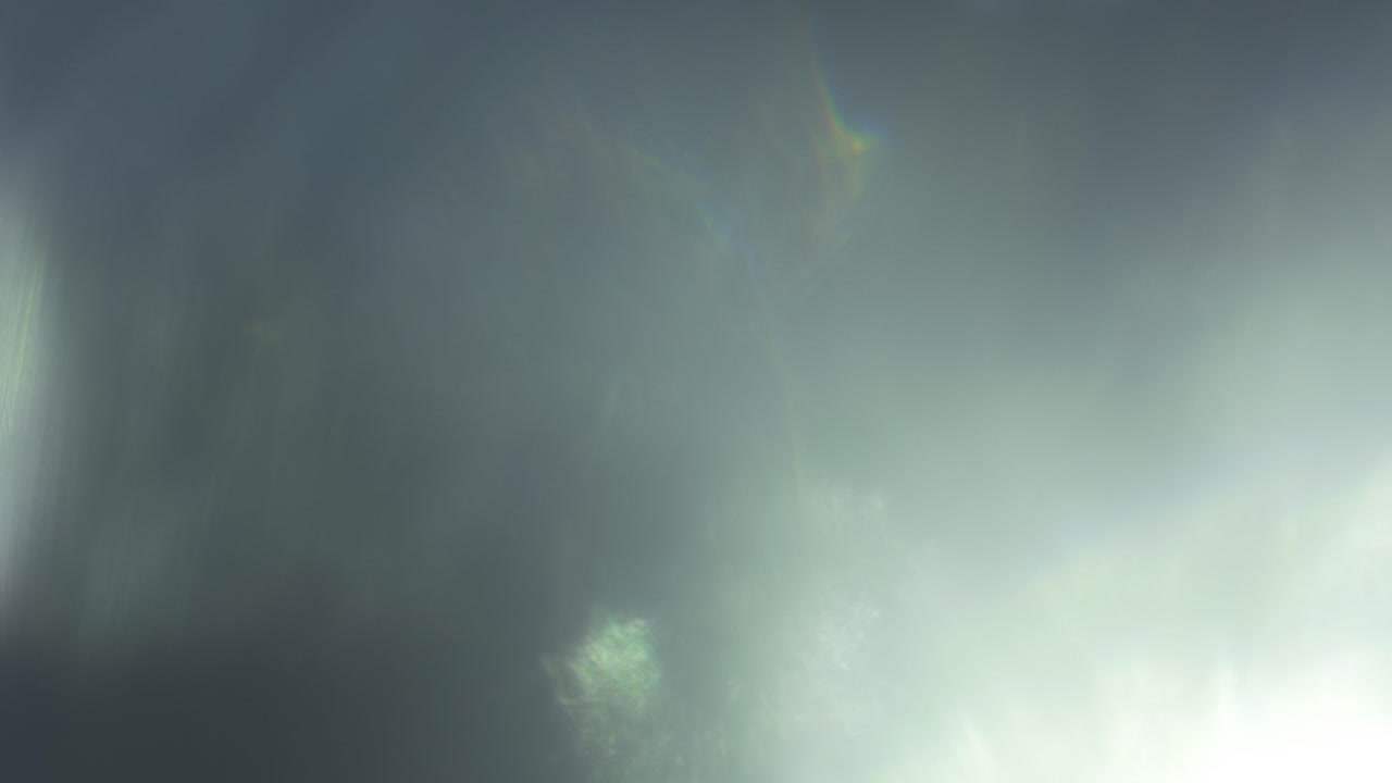 Abstract Light Leaks and Lens Flares Transitioning on Dark Background
