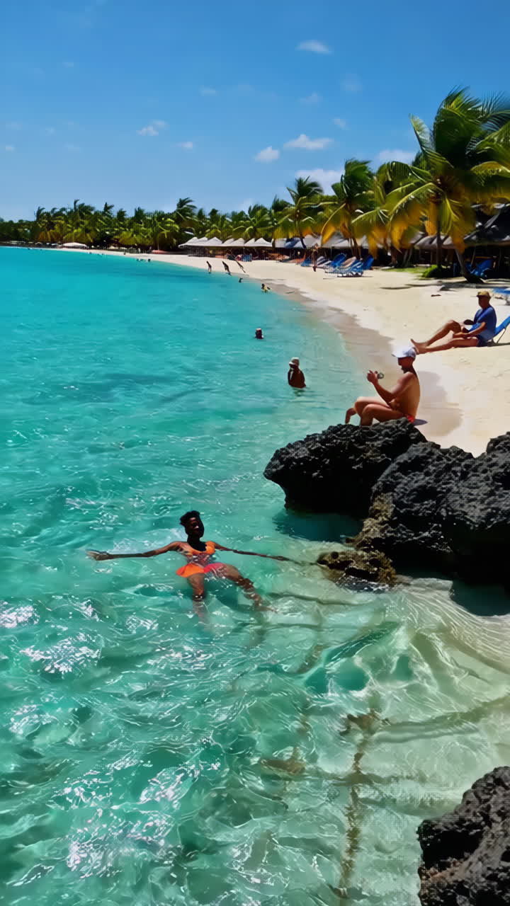 People enjoying a tropical beach vacation with clear waters and rocky shores