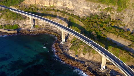 rugged mountains with coastal road at sea cliff bridge in new south wales, australia