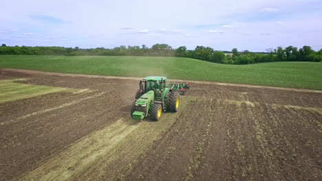 Agricultural-tractor-with-trailer-for-plowing-working-on-farming-field