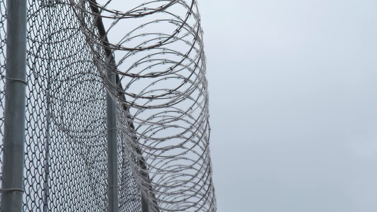 Prison Razor Wire Fence in Snow in Slow Motion