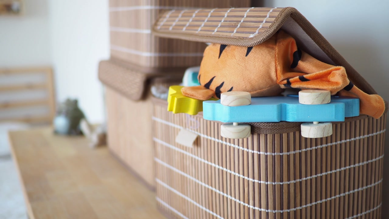 Lid of a Bamboo Storage Box Slowly Closes on Children's Toys