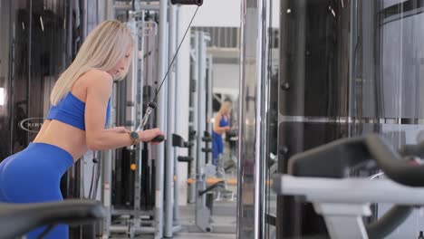 Woman working out on a cable machine in a gym
