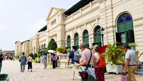 visitors walking around the grand palace area