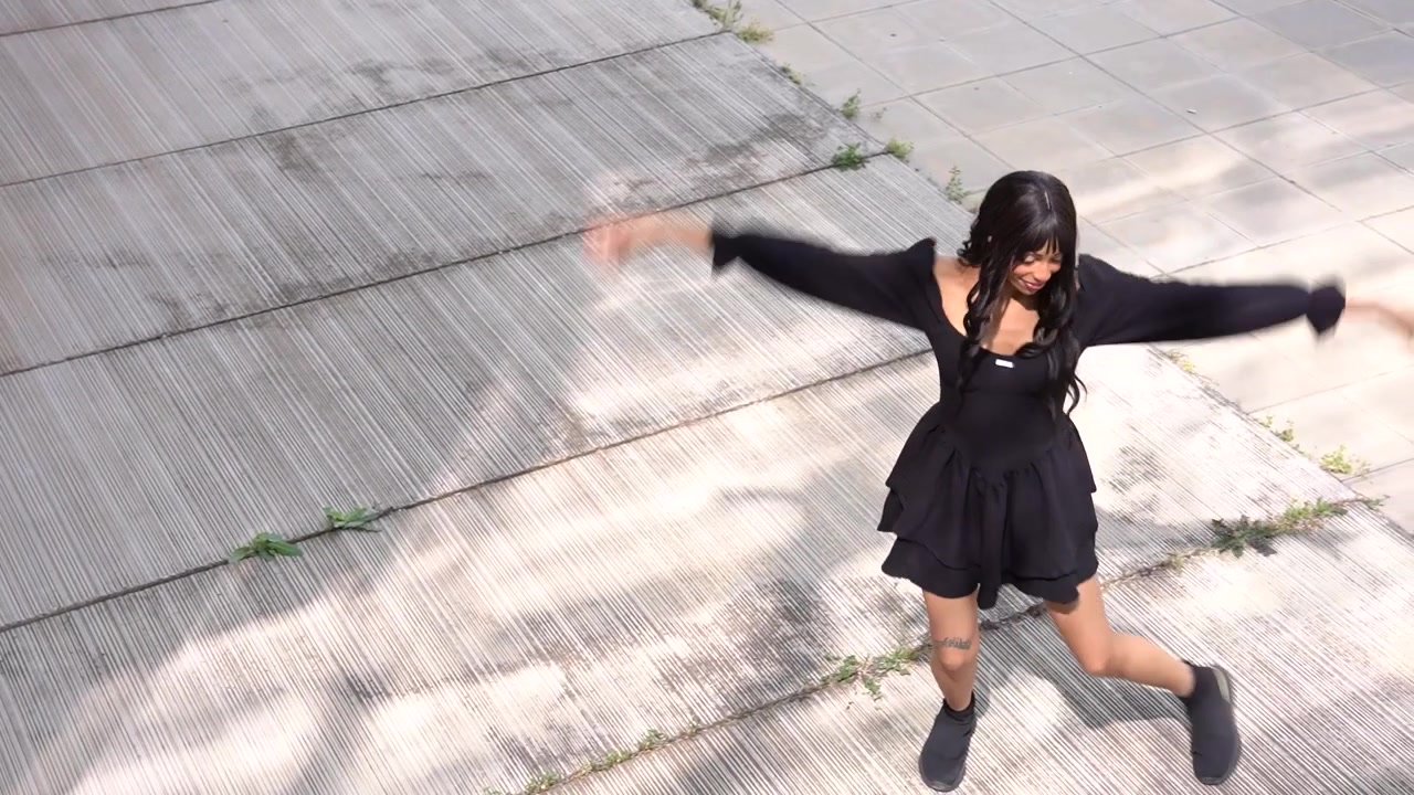 Young black woman dancing in the street