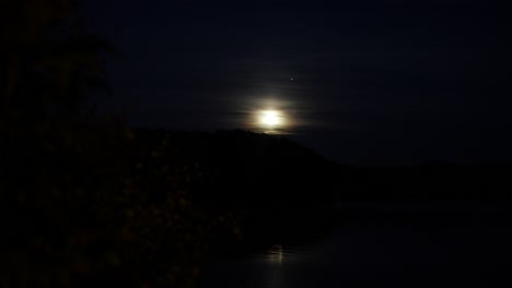 bright moon rising over hills in norway