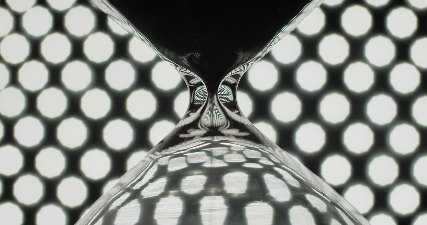 Sand clock on background of bokeh lights