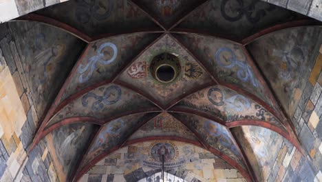 under the arch of old town bridge tower in prague, czech republic