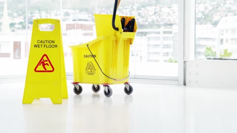 mopping bucket with caution sign