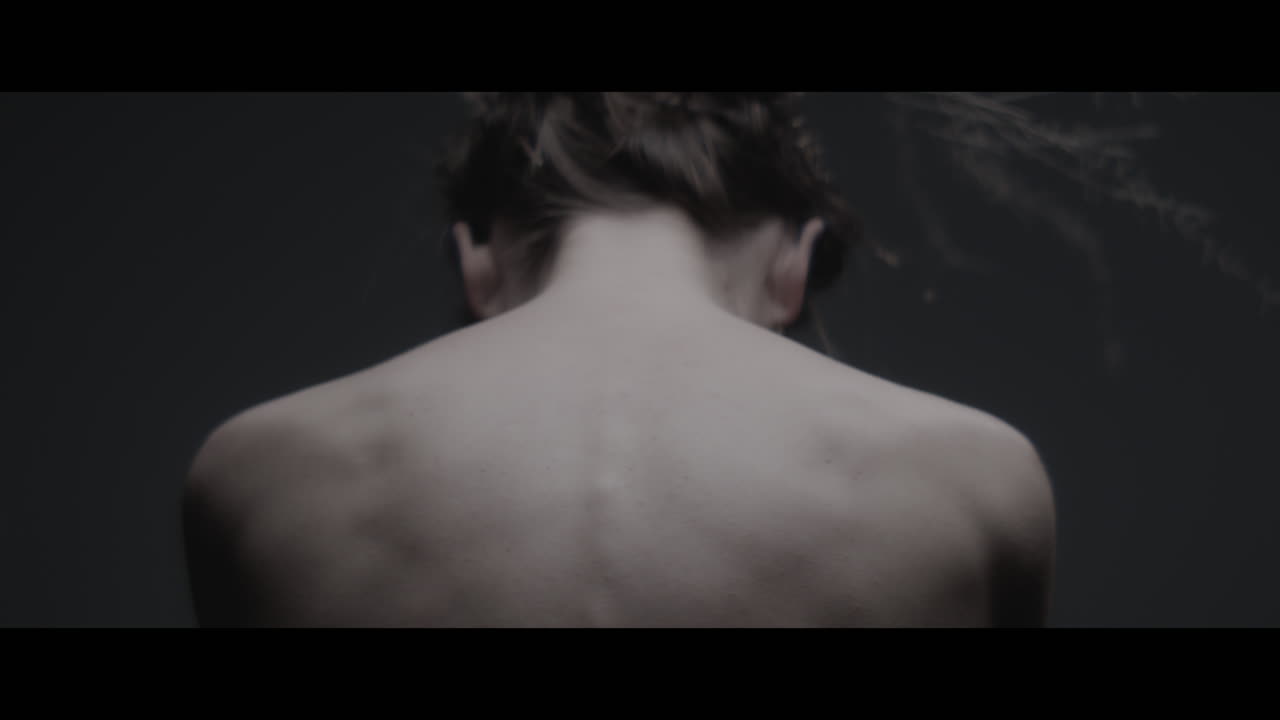 A woman dressed as mother nature shows her back