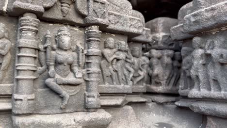 hindu deities carved beautifully on exterior walls of ancient temple in india