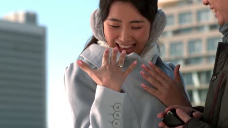 loving asian couple in winter clothes engaging