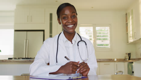 african happy american female doctor waving hand during video call consultation