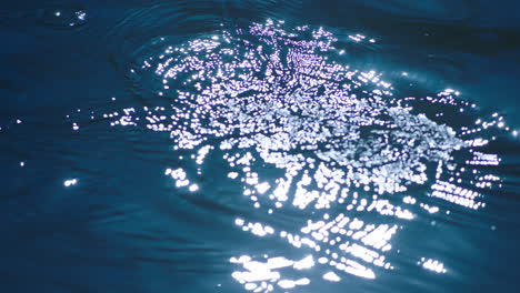 blue water with small waves and ripples in slow motion