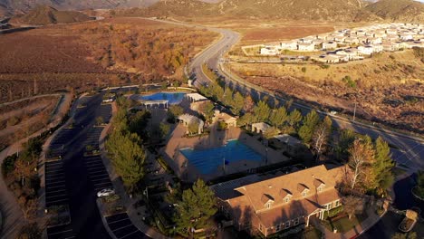 Aerial-reverse-pull-back-shot-of-a-community-pool-in-a-master-planned-community-in-the-desert
