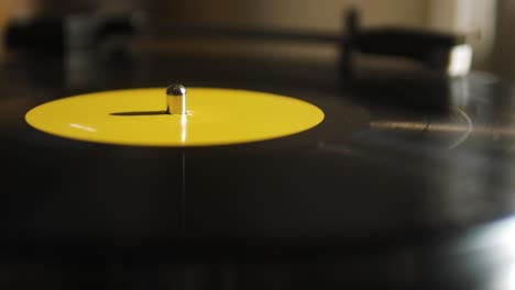 close-up eines gelben spinnenden vinyls auf einem platten-player