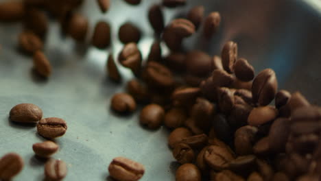 closeup coffee seeds roasting on pan in slow motion. roasted coffee beans.