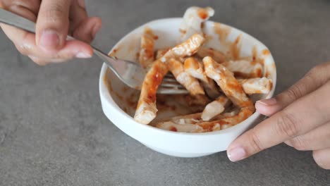 eating grilled chicken in a bowl