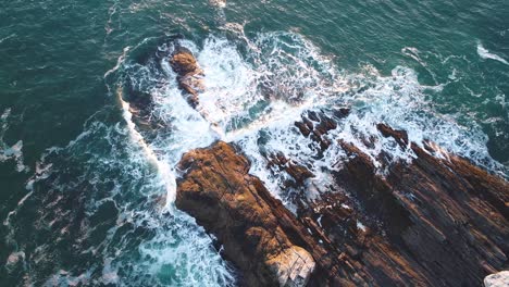 Aerial-view-of-the-edge-of-the-rocky-shore-of-Curtis-island-lighthouse-Camden-Maine-USA