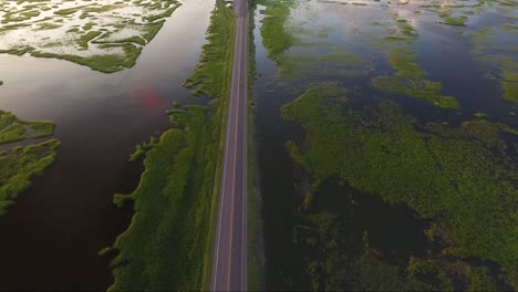 aerial footage flying forward over causeway in ocean isle beach nc at sunset