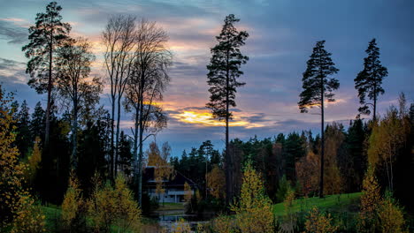 time lapse wonderful golden hour sunset over deep forest valley log cabin in distance