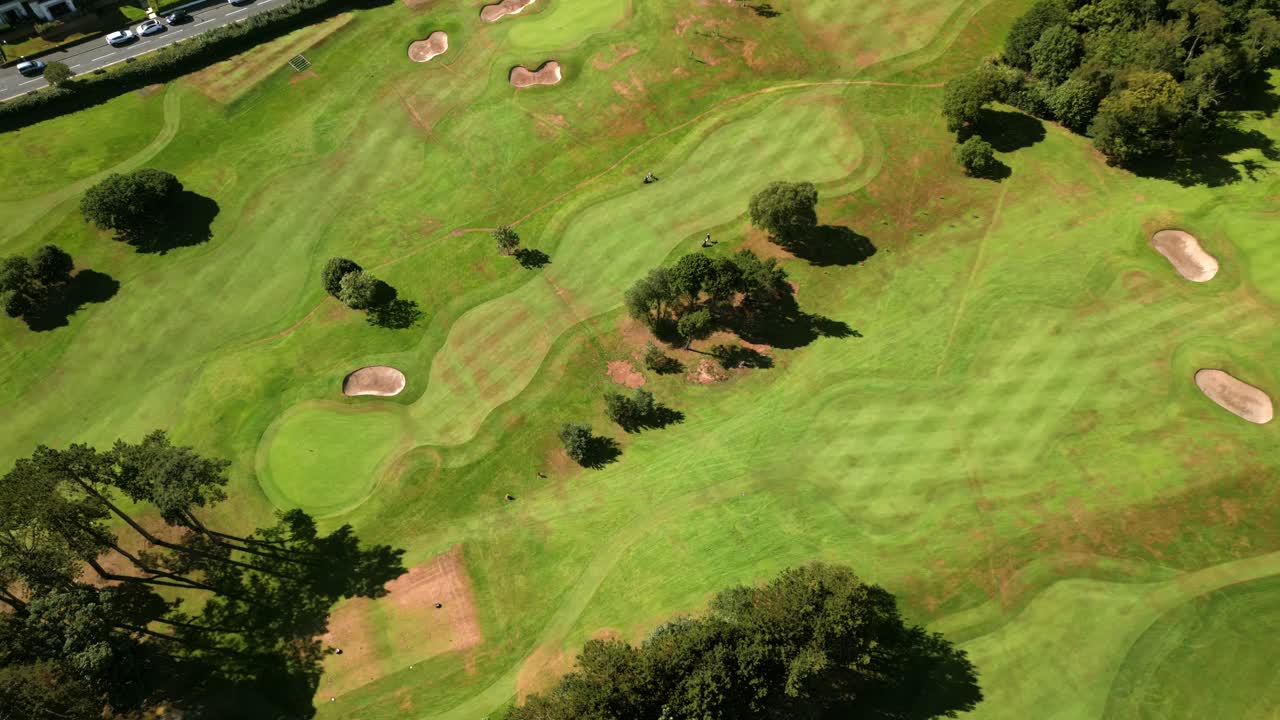 Travelling 4K 60FPS aerial of Helen's Bay Golf Club in County Down, Northern Ireland on a bright summer day. Produced with Rec709 color