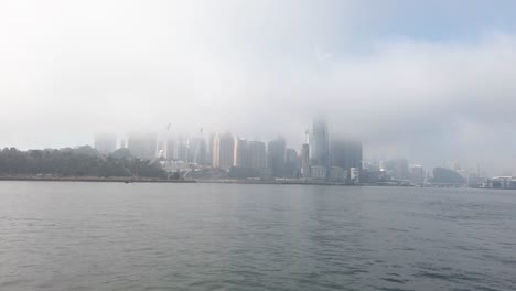 view of barangaroo while on ferry during a misty morning in sydney, new south wales, australia - wide shot