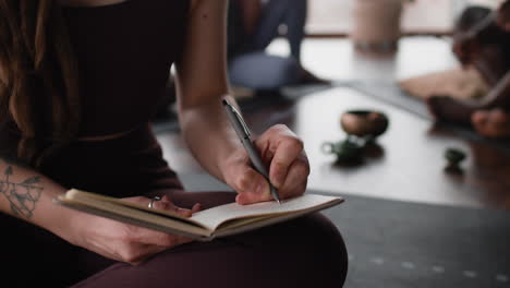 Woman Journaling in Yoga Class