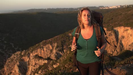 peaceful female backpacker walking on footpath