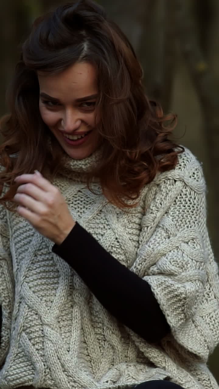 Fashion woman walking in autumn park. Outdoor fashion video of young beautiful lady surrounded autumn leaves