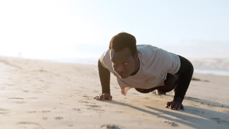 black man, pushup and fitness exercise at beach