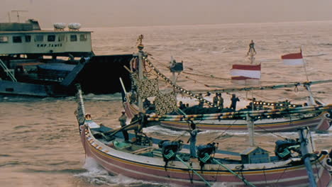 decorated boats pass a ferry boat near java indonesia