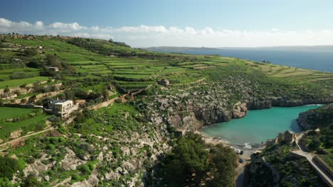 AERIAL:-Houses-on-Magrr-Ix-Xini-Bay-Which-is-Surrounded-by-Hills-and-Blue-Mediterranean-Sea-Waves