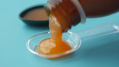 pouring golden syrup into measuring spoons