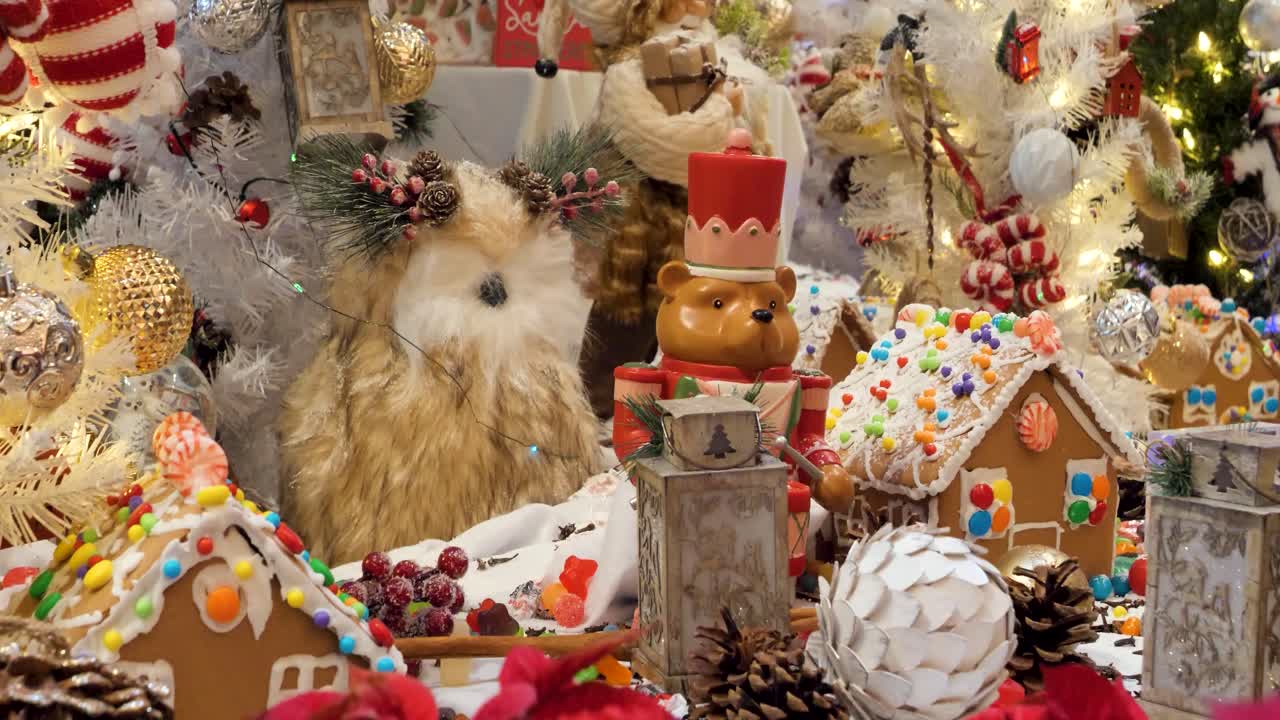 Christmas decorations arrangement, Christmas traditions with gingerbread houses, candies, toys, Christmas tree and Christmas lights.