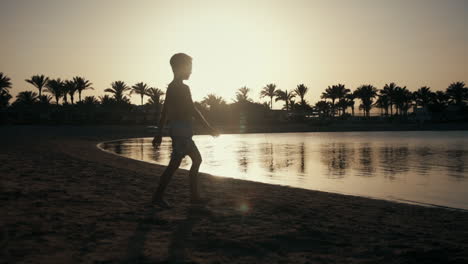 Young-man-enjoying-nature-at-seaside.-Teenage-boy-walking-on-sand-beach
