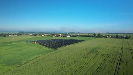 aerial view of agricultural fields with solar panels in the countryside