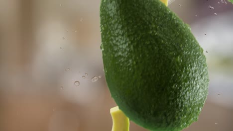 aguacate con rebanadas y salpicaduras cayendo en el fondo de la cocina