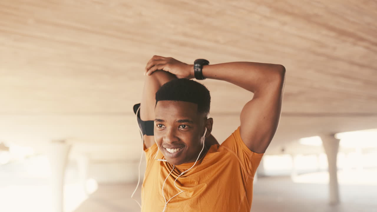 a sporty young man stretching his arms