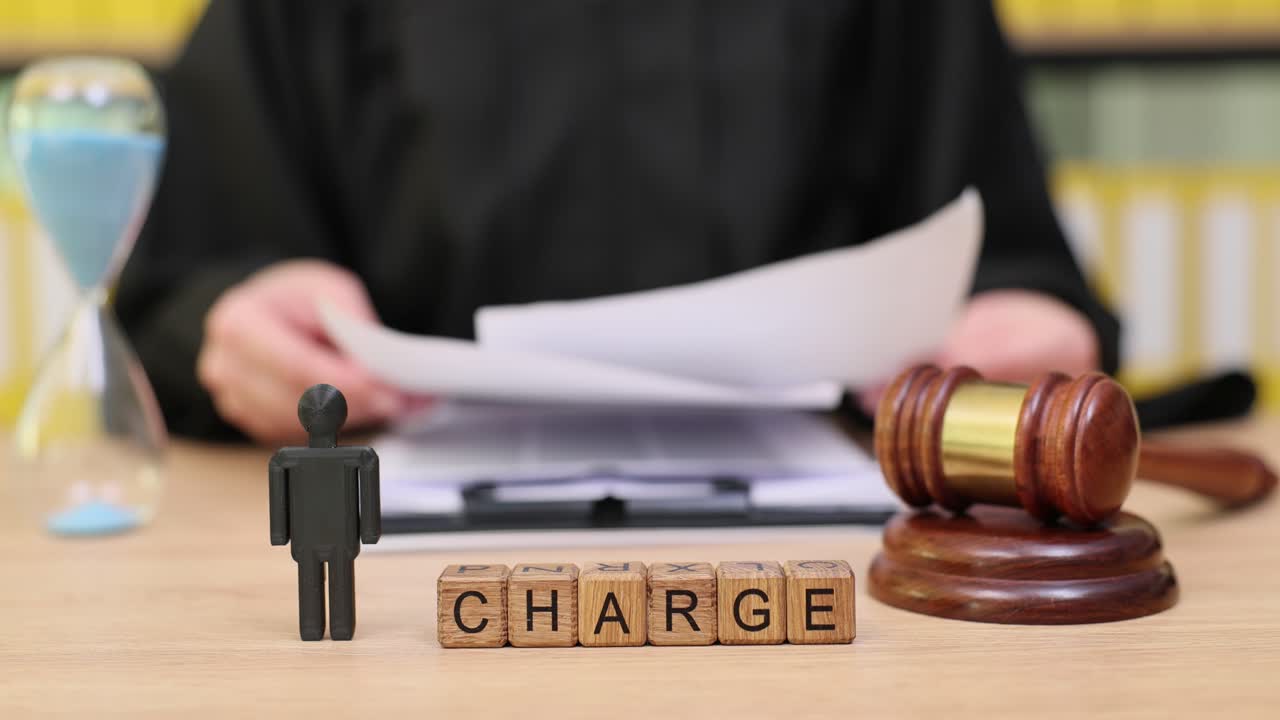 Legal Charge Concept with Gavel, Judge, and Hourglass