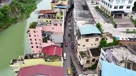 Aerial-shot-of-a-narrow-road-near-Nanxi-River-at-Yanjin-City,-Yunnan-Province