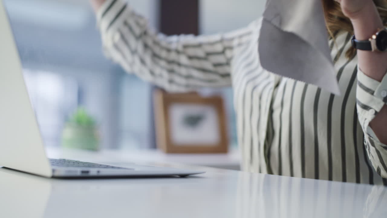 a businesswoman disinfecting her laptop