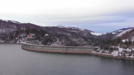 Aerial-view-of-the-Lake,-Forests-and-the-Dam-from-Valea-Draganului-in-Transylvania,-Romania